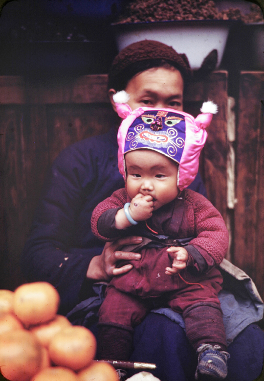 Boy with silk animal face hat, Kunming, 1945