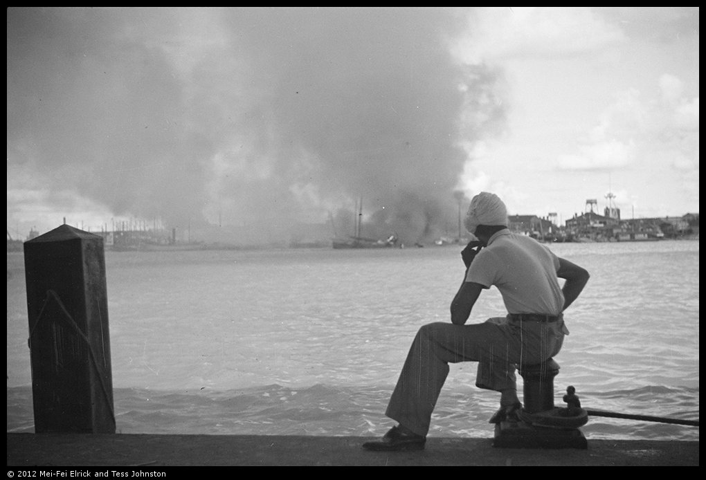 Sikh man looking over Huangpu towards fires in Pudong, Shanghai, Rosholt Collection, Ro-n0382.