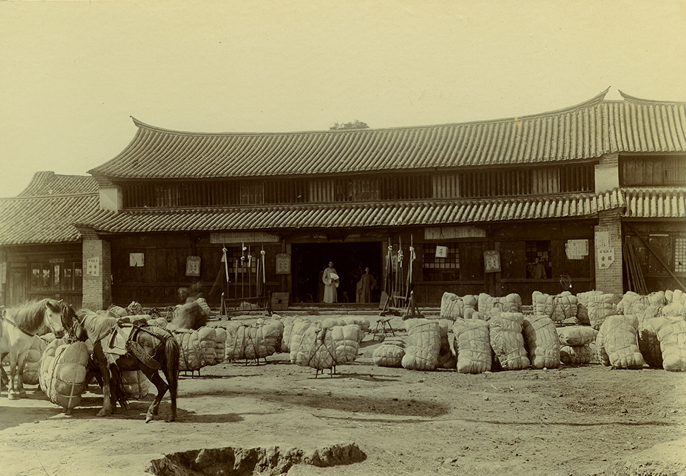 Custom House at Szemao; bales of cotton from the British Shan States sit outside. © Royal Geographical Society (with IBG).