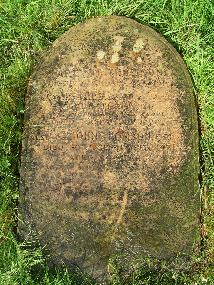 The fallen over grave stone of John Thomson, who is buried alongside his wife and his son Arthur, in Streatham Cemetery, Tooting, London. Photograph by Terry Bennett.