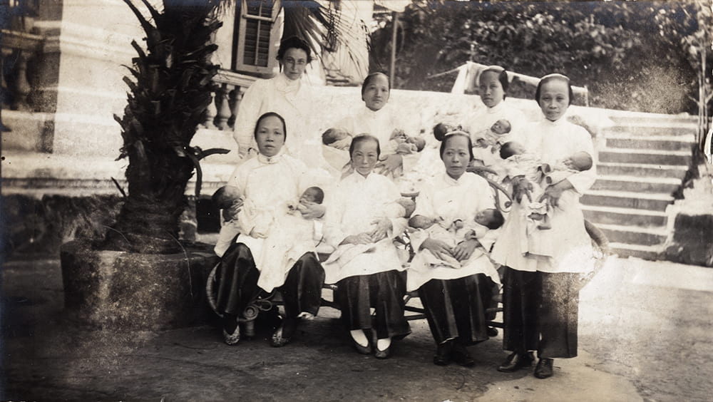 Dr Eleanor Whitworth Mitchell with nurses and newly born babies, outside a maternity hospital, Hong Kong. Historical Photographs of China ref: Mi01-016.