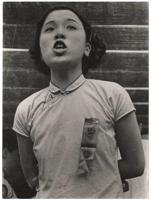A woman speaking at a parade commemorating the thirteenth anniversary of Sun Yat-sen’s death and the first anniversary of the Sino-Japanese War, Hankou, China. Photograph by Robert Capa. © Cornell Capa.