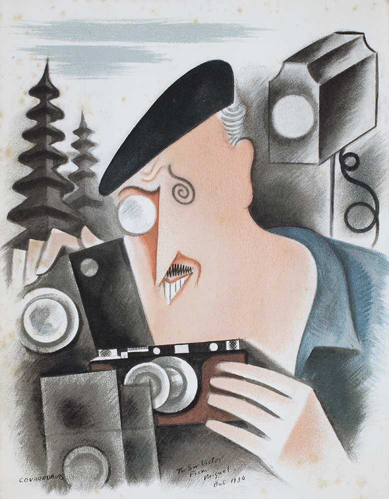 A print of a caricature by Miguel Covarrubias, of the successful businessman Sir Victor Sassoon with a Leica camera and lighting kit, in Bali, dated 1934. Sir Victor loved photography, horse racing, travel, international friendship and the party life of 1930s Shanghai. This print is in a scrapbook in the George Hutton Potts Collection (DM2831/21).