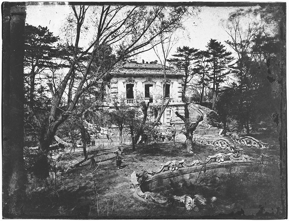 Fig. 1: The Fangwaiguan (the ‘Look Abroad Hall’ or ‘Belvedere’), showing flamboyant marble balustrades and bridges, and its Chinese-style roof. A man waits for the photographer to take the picture, with his hands on his hips. The Fangwaiguan was the only large building at the Xiyanglou which survived the burning with its roof intact. Photograph by C.F. Moore. Royal BC Museum, ref J-00443.