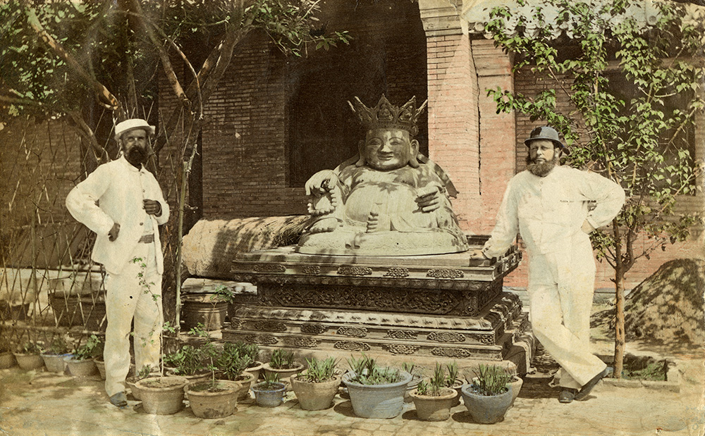 Fig. 1. A gilded bronze Buddha, with two unidentified men, British Legation, Beijing, c. 1869. A rare, hand-coloured print of a photograph by Charles Frederick Moore. Image courtesy of the Terry Bennett Collection (ref: BPEK-3).