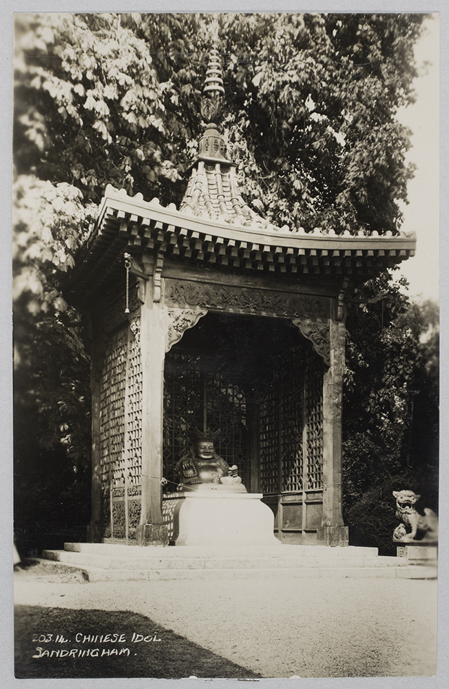 Fig. 3. The ‘Chinese Idol,’ at Sandringham House, Norfolk, England, c.1925. The Chinoiserie wooden ‘pagoda’ over the sculpture was put up by estate carpenters, for Edward, Prince of Wales, in the 1870s. The canopy was demolished in 1960, as the woodwork had become rotten. The Buddha was (and still is) flanked by two granite Japanese lions, also presented by Admiral Keppel.