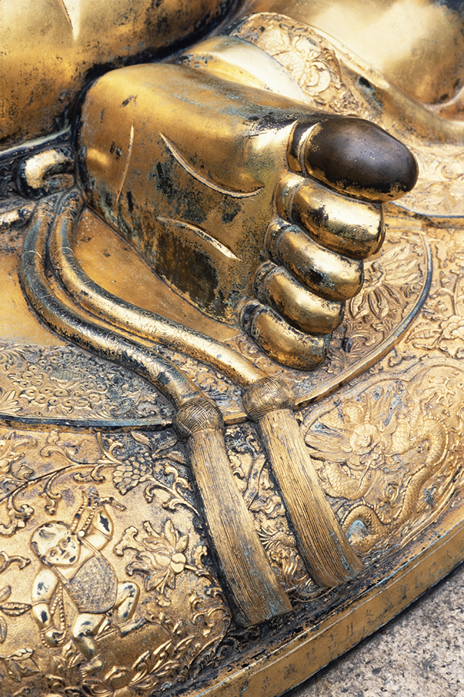 Fig. 6. The Sandringham Buddha’s big toe, the gilt rubbed off for luck, or in veneration, by visitors, who also nowadays leave coins in his lap. Photograph by Jamie Carstairs. A memory of taking photographs of the Buddha in 1994 surfaced this summer, along with figs. 1 and 3, to connect the Sandringham Buddha with the Beijing Buddha photographed by Charles Frederick Moore.